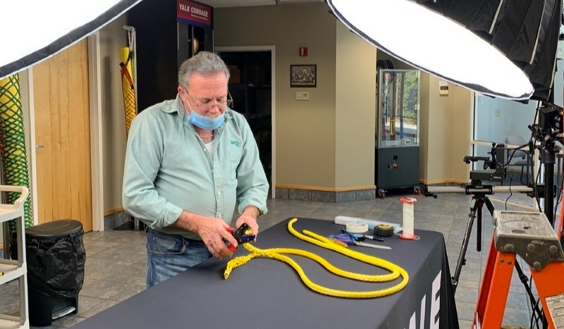 Factory worker splicing rope for social media content