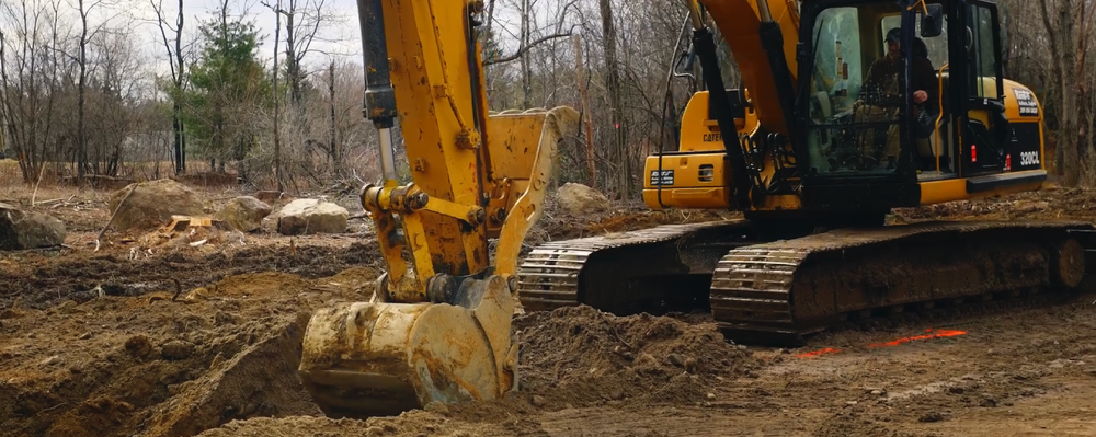 Excavator digging dirt - construction company marketing content