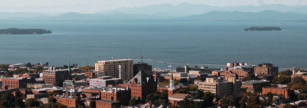 aerial image of burlington vermont looking across lake champlain. screen shot from burlington police department recruitment video