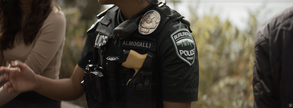 screen shot of a burlington, vermont police officer speaking with community members. This is from a recruitment video produced by horizon visual media for burlington police department.