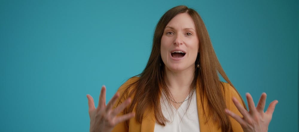 still frame from a testimonial video, promotional video production, woman talking to camera