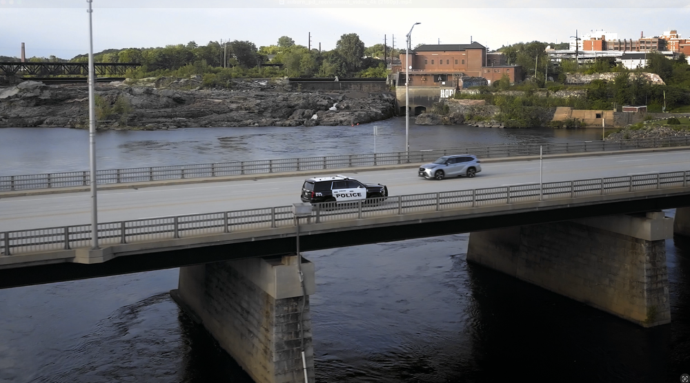 Police cruiser driving into lewiston, maine. photo taken by a video production company in lewiston, Maine